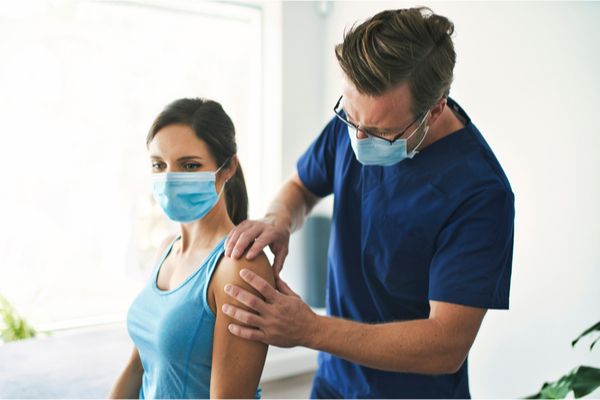 a physiotherapist treating a patient in a clinic 