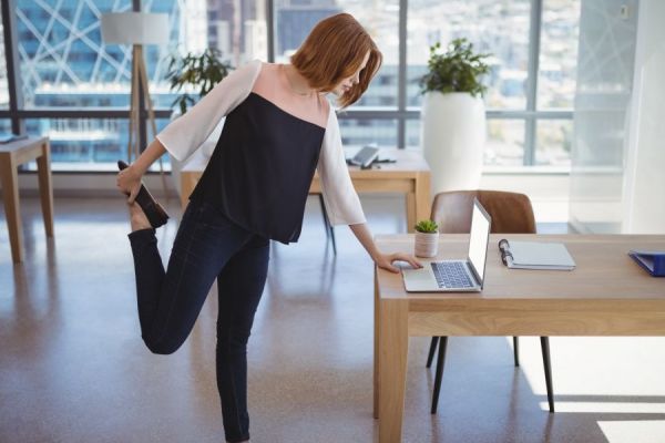 Woman stretching at desk