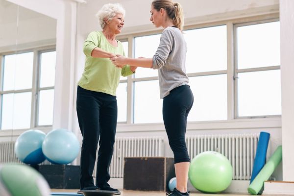 Senior woman receiving treatment for balance and BPPV with physiotherapist