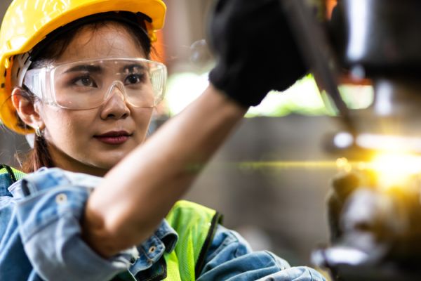 Female mechanic operating tools