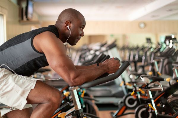 A man using a cycling bike in a gym