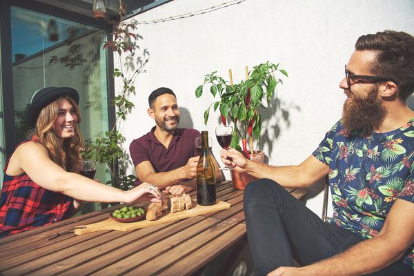 a group of friend's enjoying a drink outdoors 