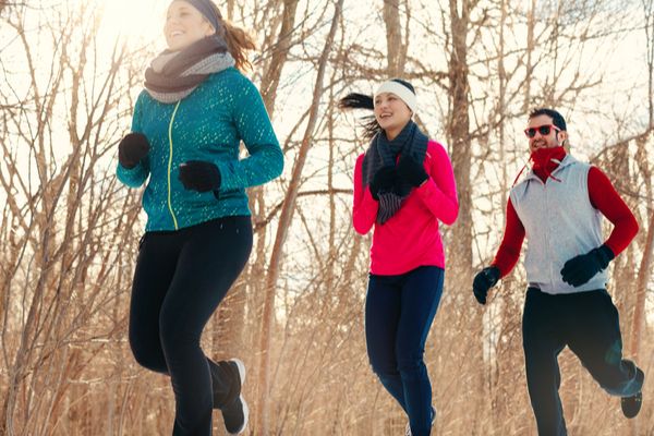 a group of friends running in the winter 