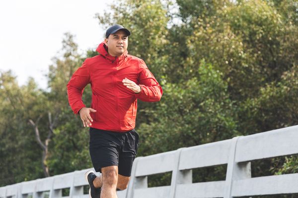 young man jogging park afternoon