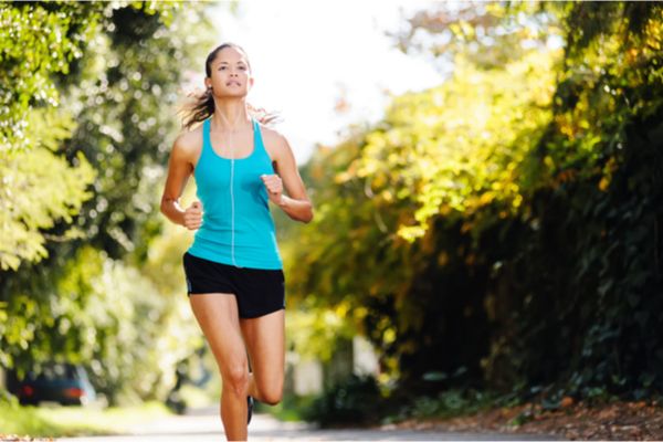 a woman running outside with earphones