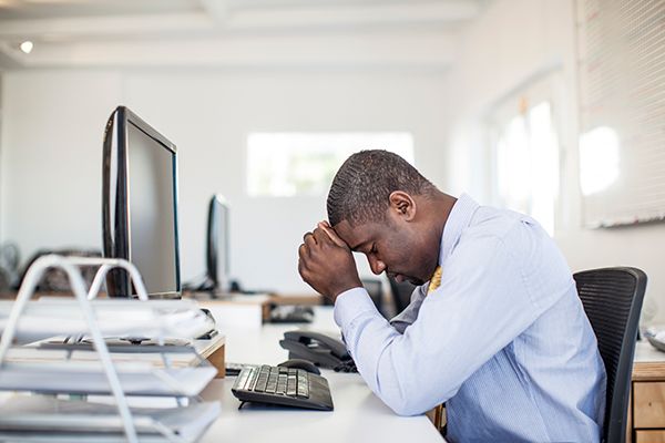 Man with concussion at desk