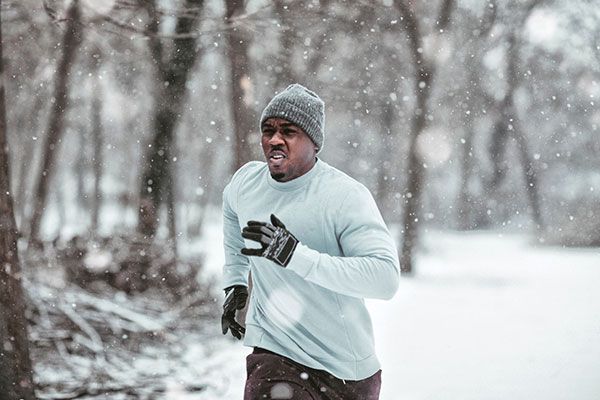 Man running in the winter in the woods