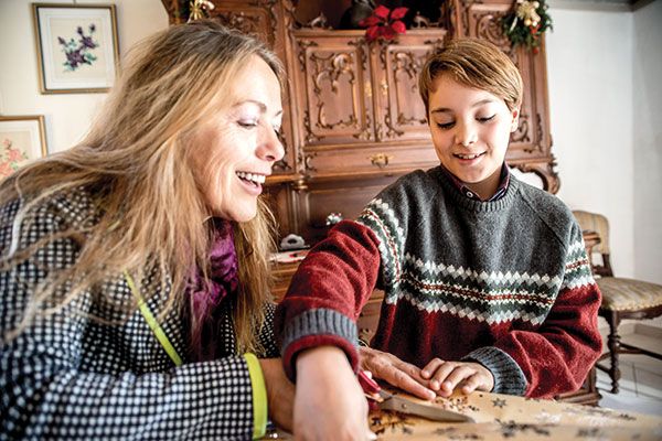 Mother and son wrapping presents together