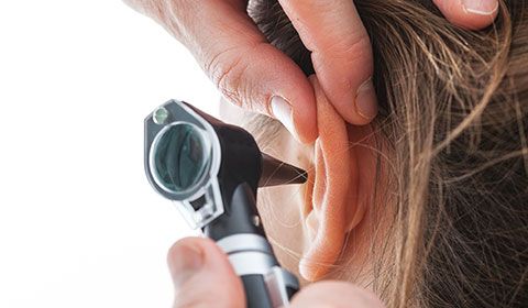 ear check-up being performed on a patient