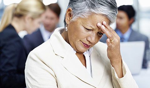 Woman in meeting feeling dizzy and light headed