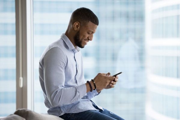 Man with head facing down while texting