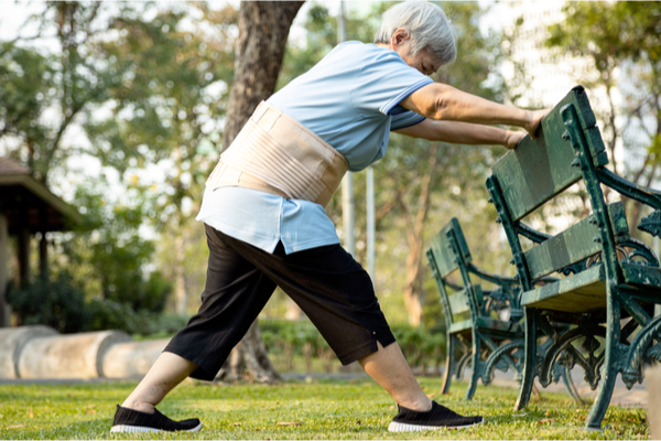 senior woman exercising by stretching the leg muscles