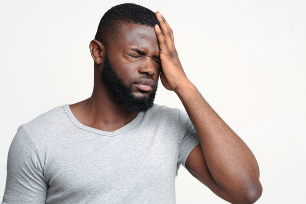 A young man experiencing concussion symptoms