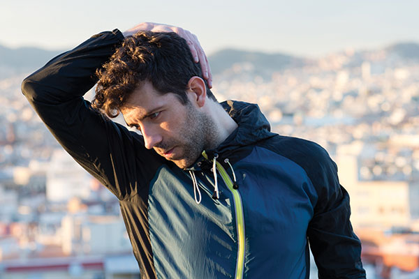 man stretching neck before running