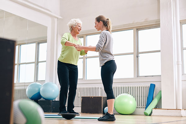 physio working with woman on balance