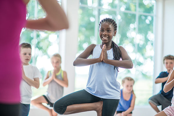 teenage girl doing yoga pose